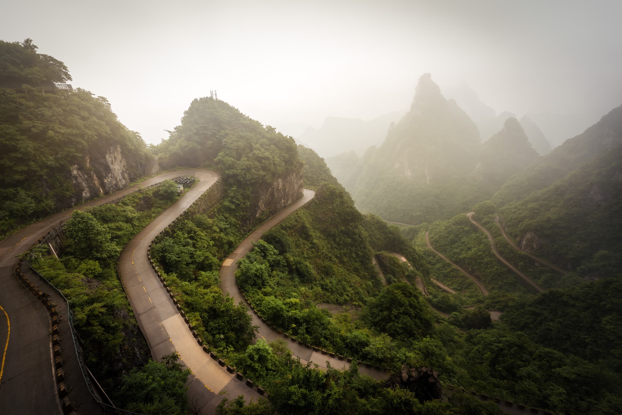 The winding mountain road through misty Tianmen Mountain in Zhangjiajie, China