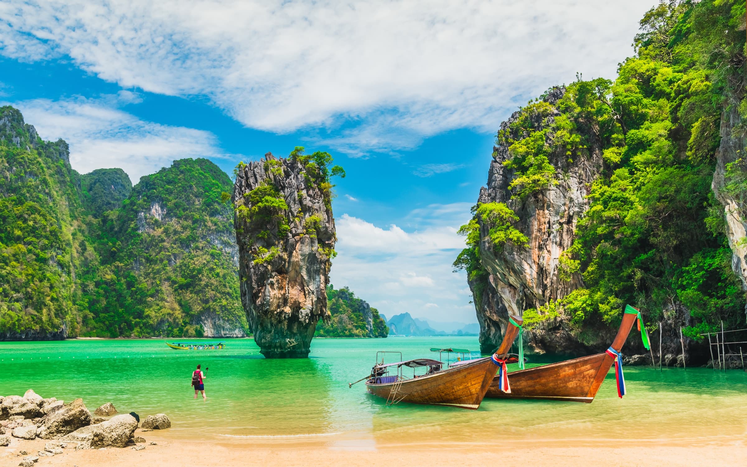 Longtail boats beside the limestone karsts of Phang Nga Bay, Thailand