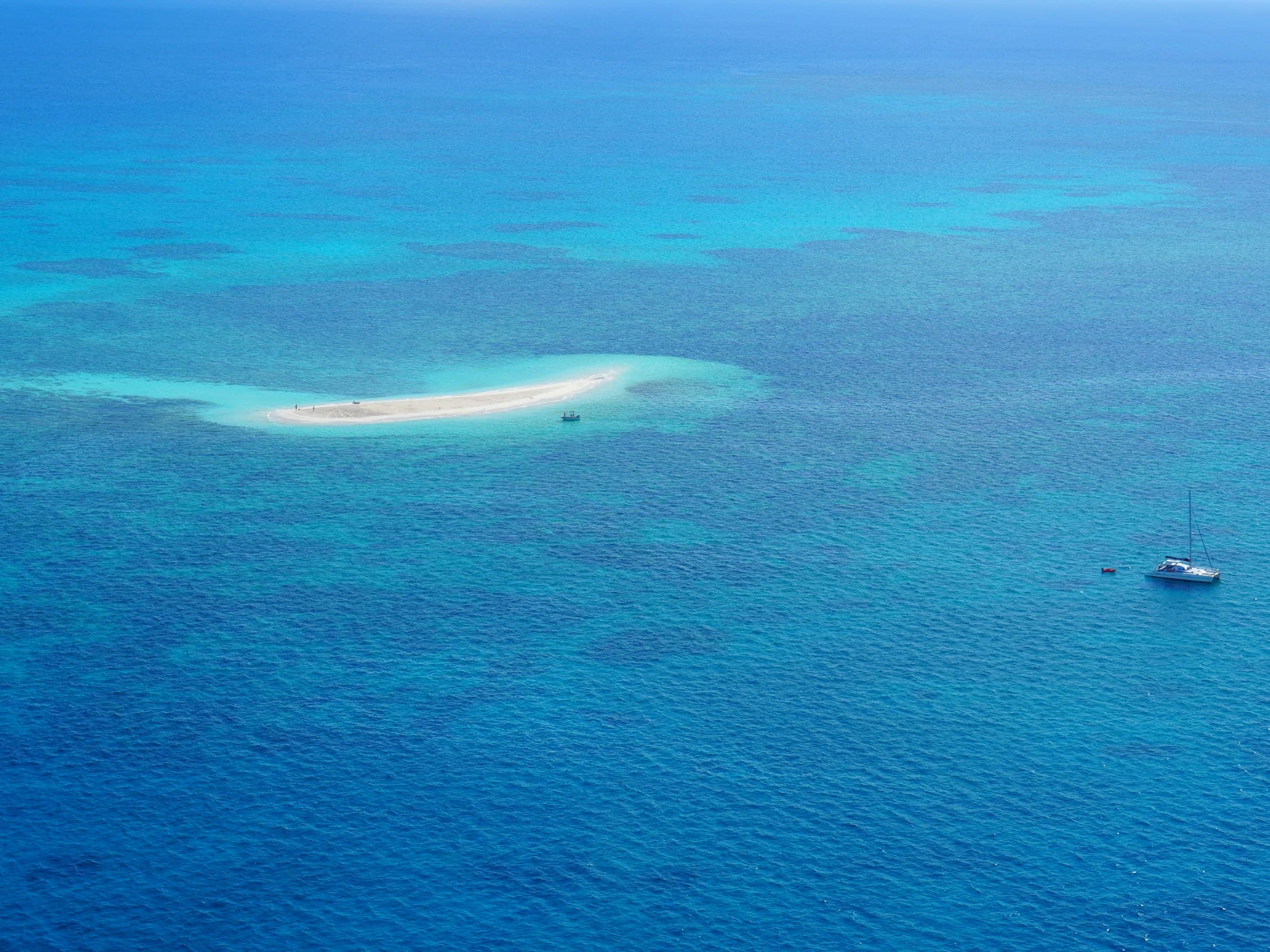 A boat beside a reef island on the Great Barrier Reef, Australia